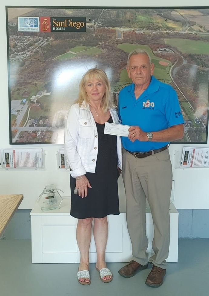 SanDiego Homes donates $1000. (L) SanDiego Homes President Sandra Rizzardo, (R) Angus Legion President Howie Hipwell.